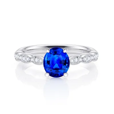 Anillo de oro 18K con zafiro oval de 1.19 ct y 18 Brillantes de 0.14 ct GVS