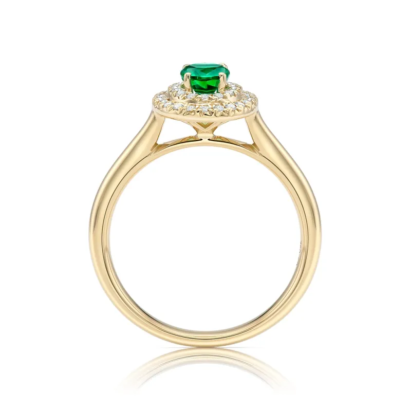 Anillo clásico con una Esmeralda de talla Oval rodeada por una fina orla de brillantes